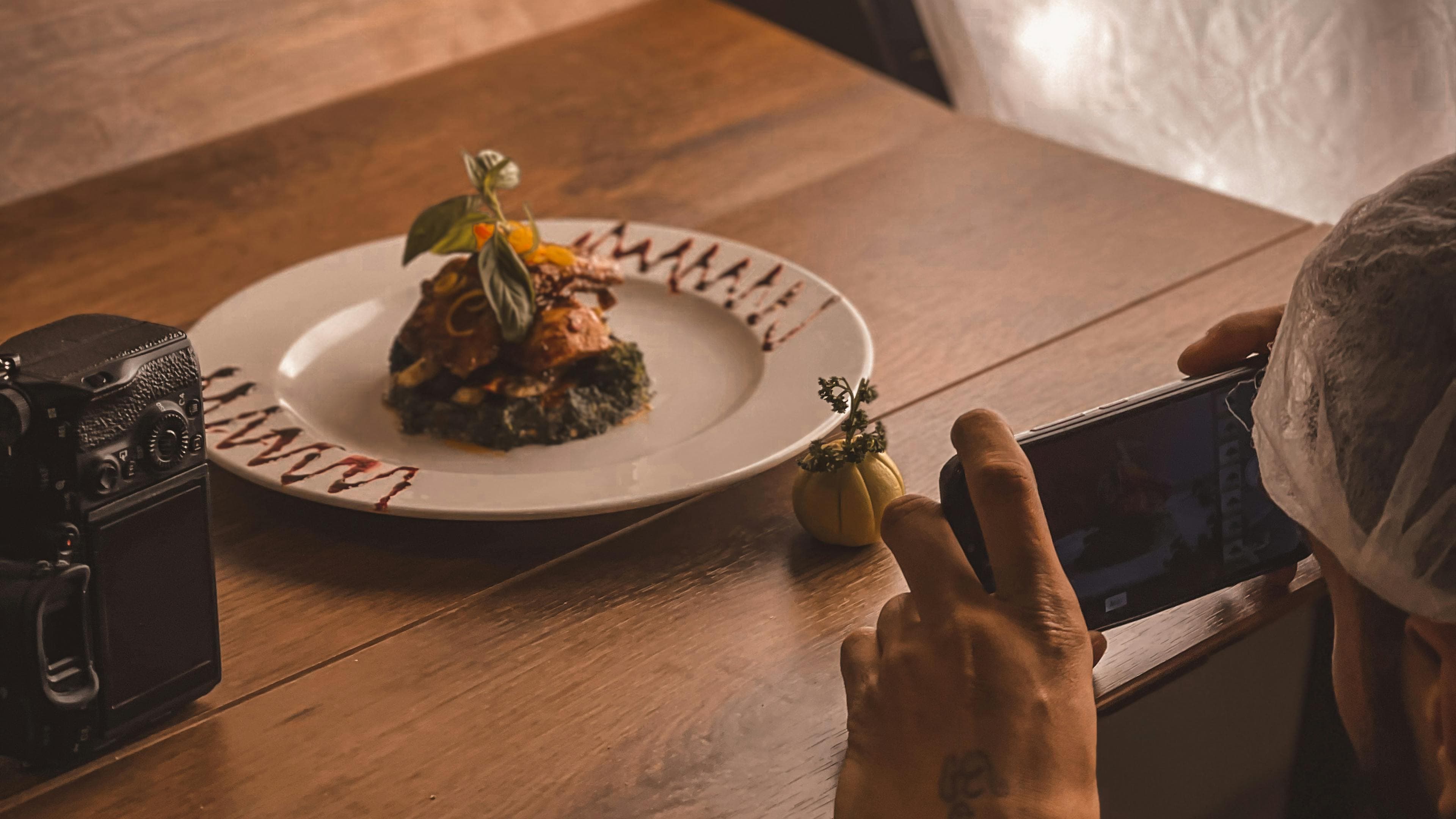 Plated tasting course with precise finishing and negative space on the plate