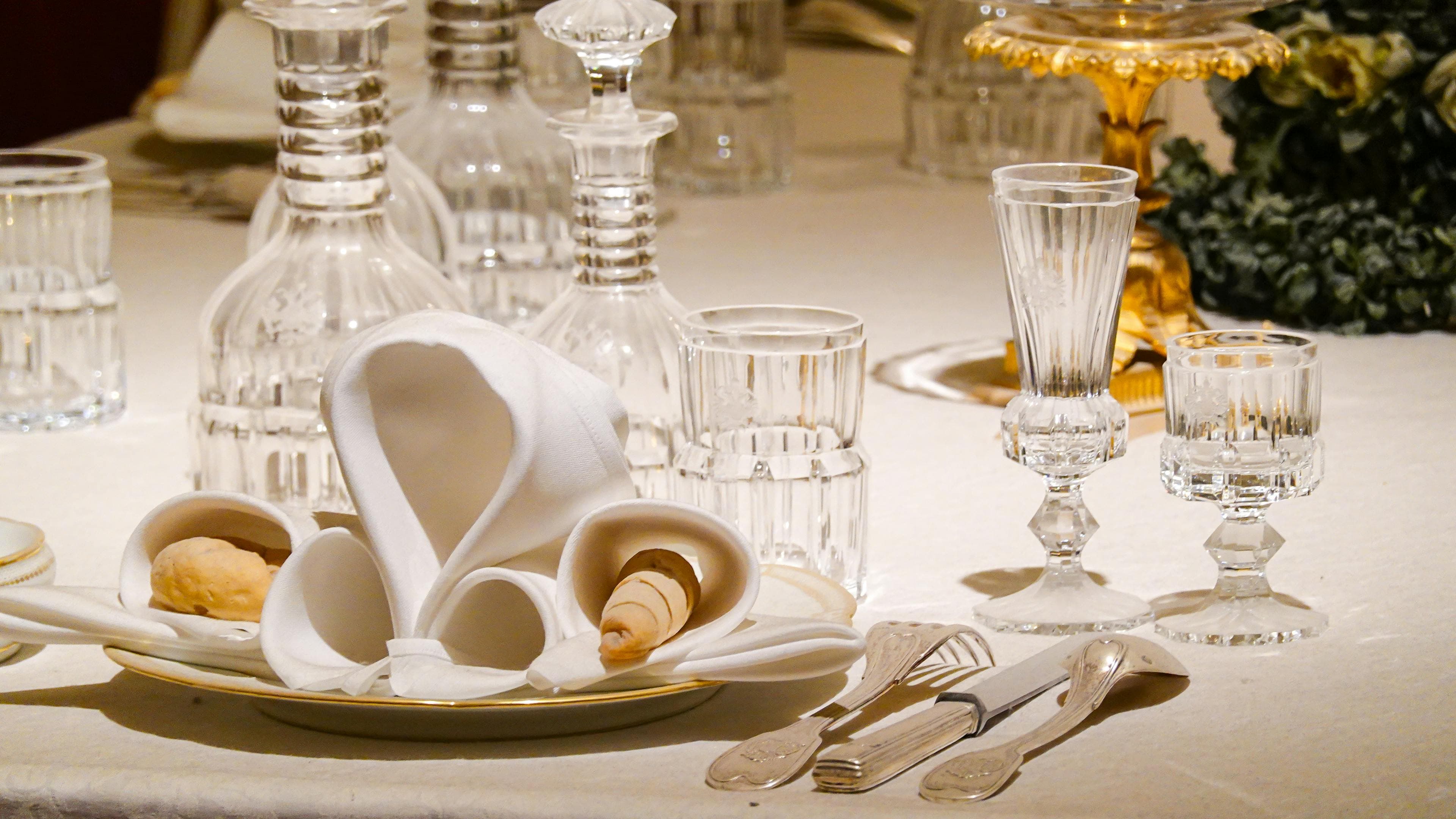 Private residence table prepared with linen and glass for discreet evening service
